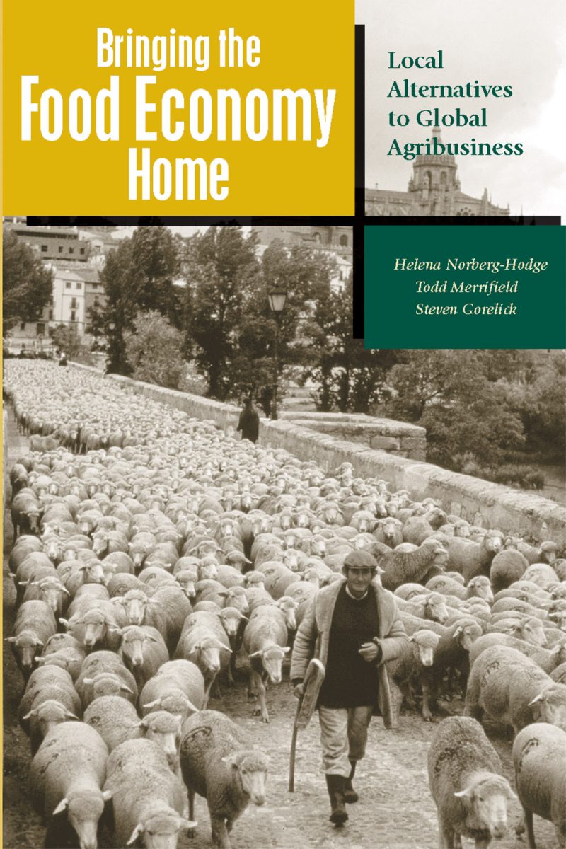 Book cover showing a person herding sheep in a pastoral landscape, with title "Bringing the Food Economy Home" and subtitle "Local Alternatives to Global Agribusiness."