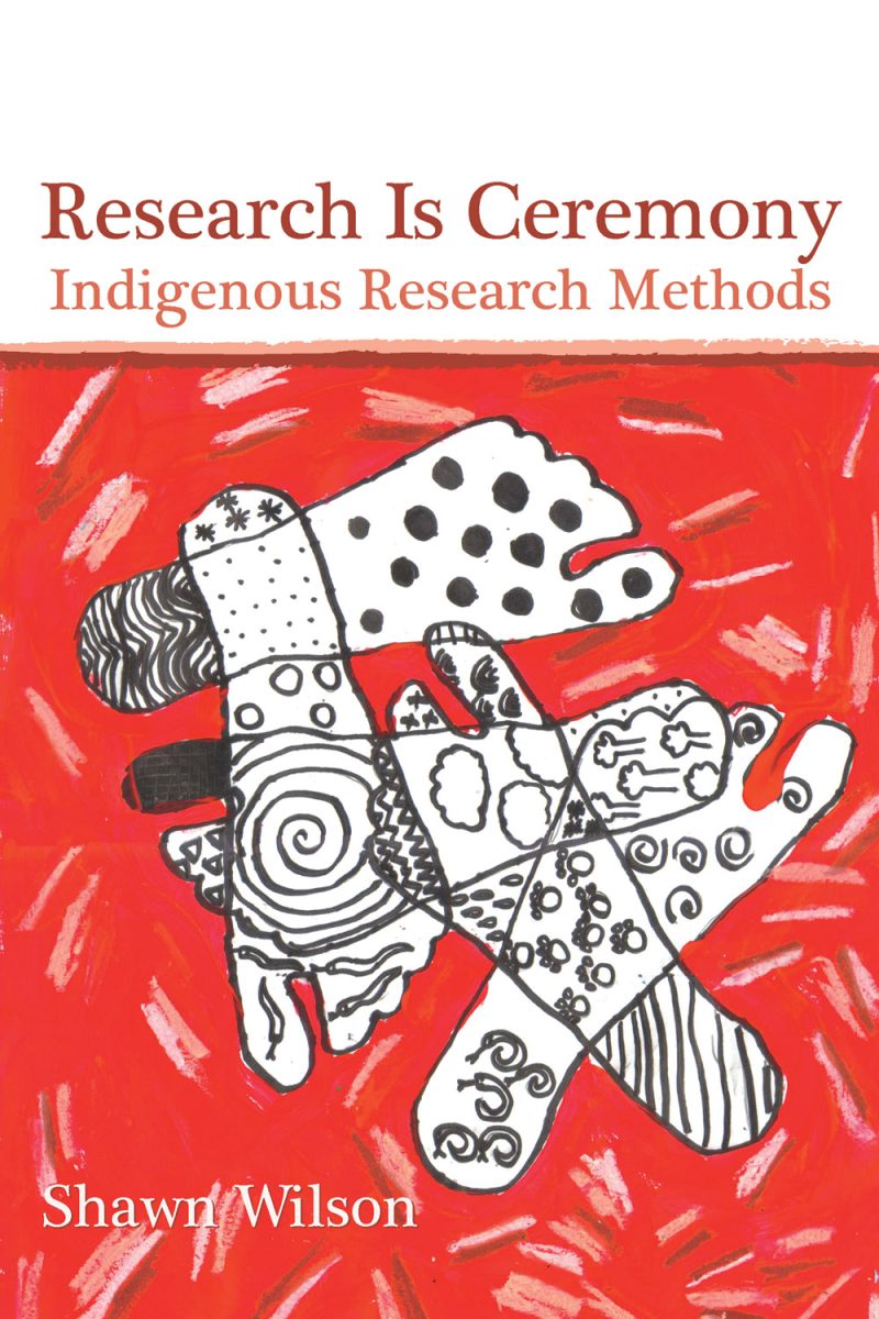 Book cover "Research Is Ceremony: Indigenous Research Methods" by Shawn Wilson, featuring Indigenous-inspired artwork with stylized hands on red background.