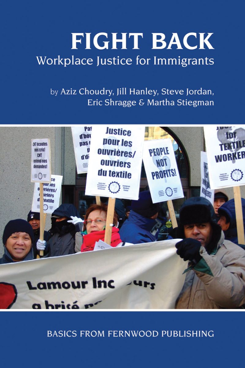 Workers holding protest signs demanding justice for textile workers and fair wages at a labor demonstration.