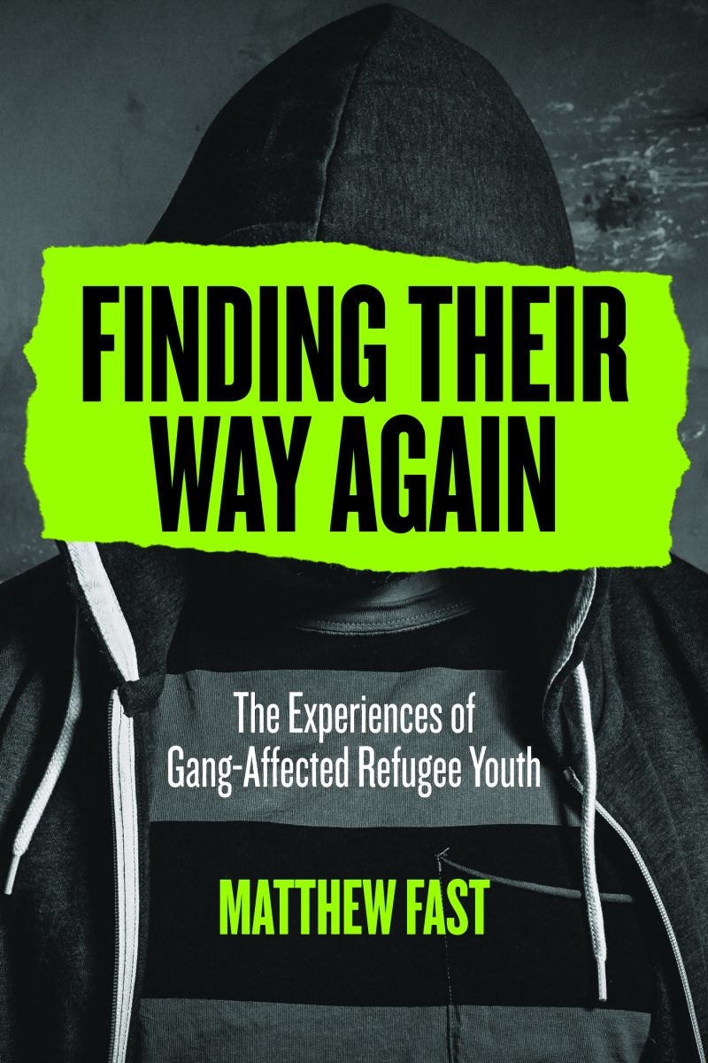 Book cover with a person in dark hoodie against gray background, bright neon green text reading "Finding Their Way Again: The Experiences of Gang-Affected Refugee Youth" by Matthew Fast.