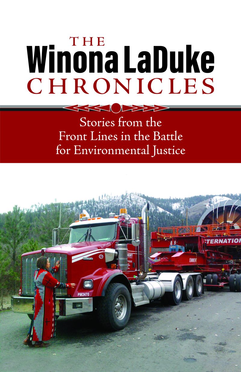 Book cover for "The Winona LaDuke Chronicles" featuring a red truck and logging equipment with forested mountains in background.