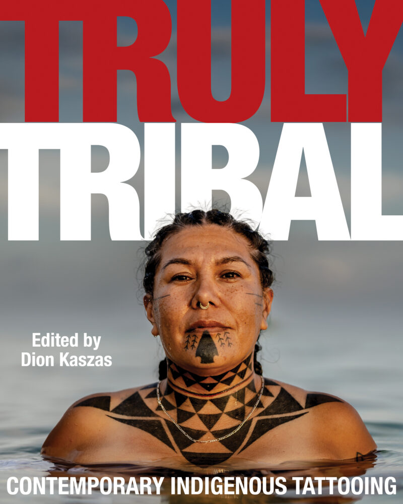 Book cover featuring a person with traditional facial and body tattoos in water, titled "Truly Tribal: Contemporary Indigenous Tattooing," edited by Dion Kaszas.