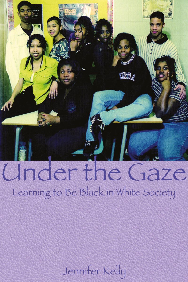 Book cover "Under the Gaze: Learning to Be Black in White Society" by Jennifer Kelly, showing a group of nine young people posing together indoors.