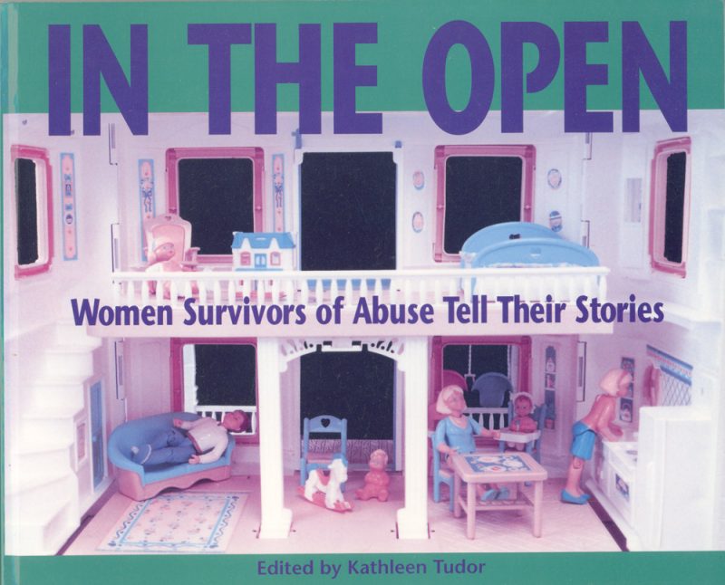 Book cover showing a dollhouse with pink rooms and blue furniture. Title reads "In The Open: Women Survivors of Abuse Tell Their Stories," edited by Kathleen Tudor.