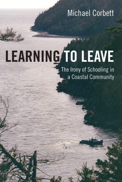Book cover for "Learning to Leave" by Michael Corbett showing a coastal landscape with forested hills, calm water, and a small fishing boat.