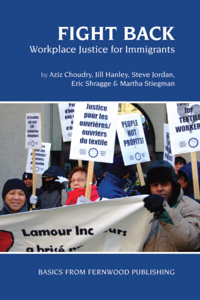 Workers holding protest signs demanding justice for textile workers and fair wages at a labor demonstration.