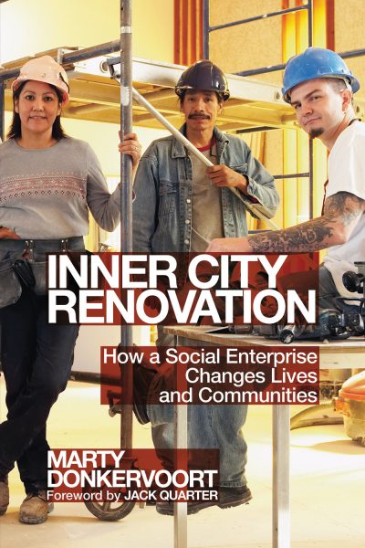 Three construction workers in hard hats holding tools on a renovation site, book cover for "Inner City Renovation" by Marty Donkervoort.