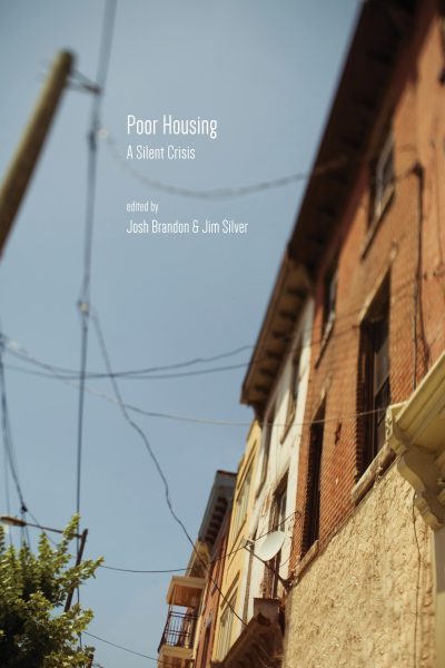 Book cover for "Poor Housing: A Silent Crisis" edited by Josh Brandon and Jim Silver, featuring an angled view of a brick residential building against a blue sky.
